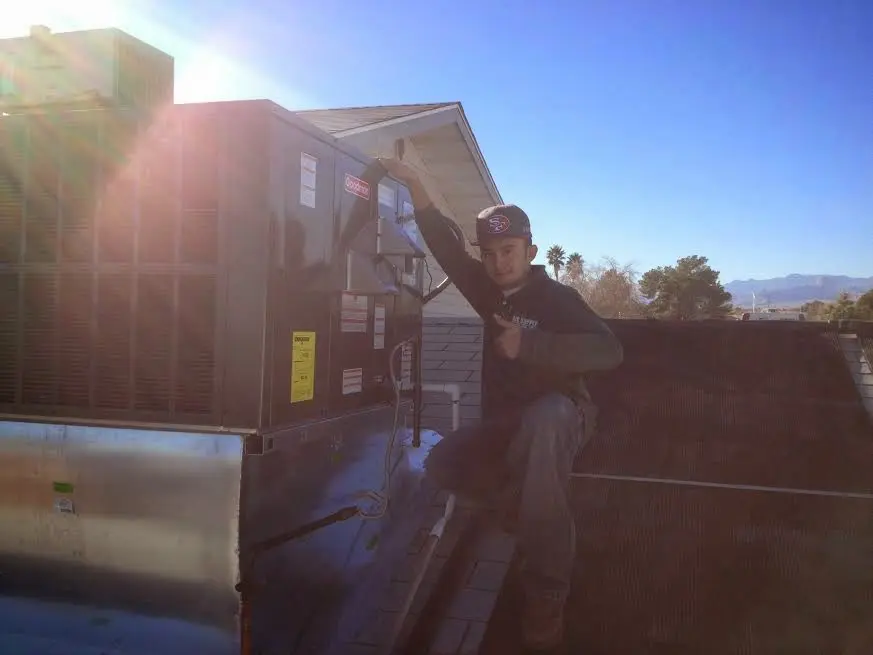 HVAC technician performing Heat Pump Repair on a rooftop unit in Orange Park